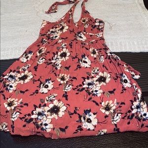 A pink dress with white and navy flowers on it